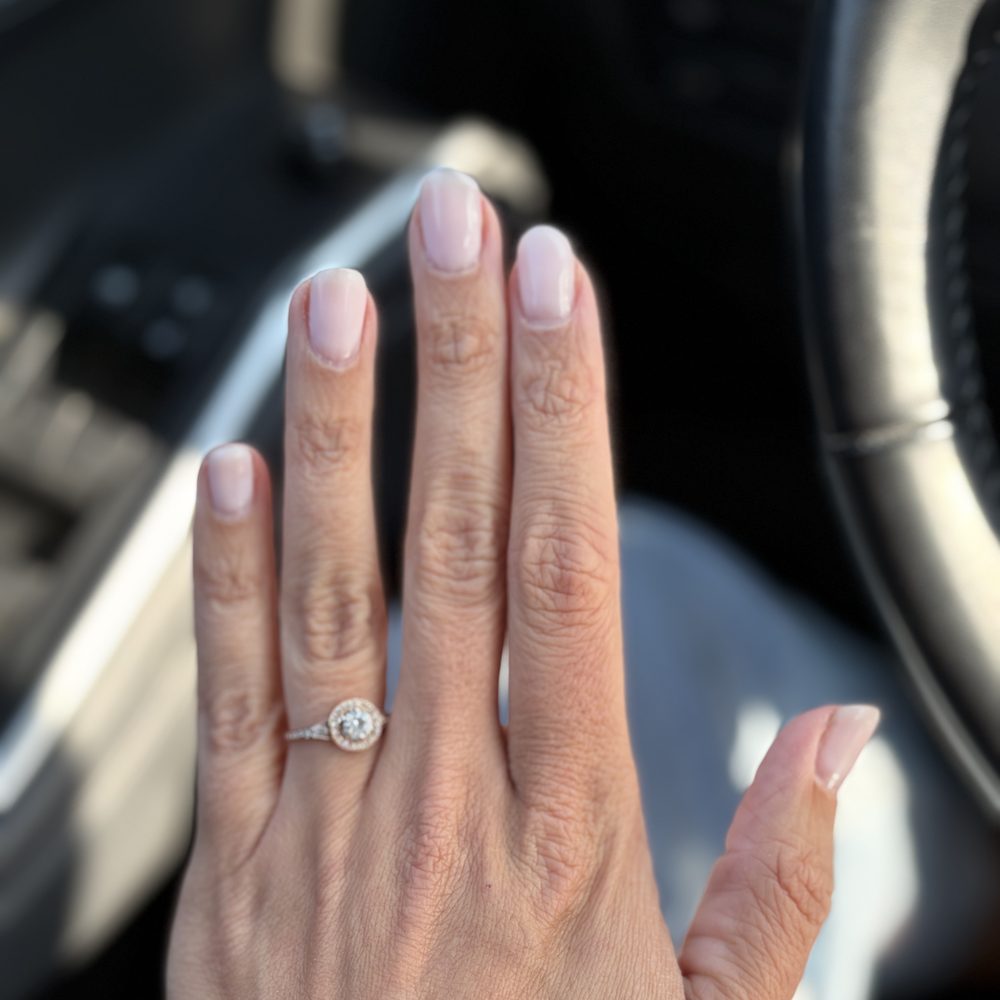 A pale pink set freshly filled and rebalanced, shown on one hand.