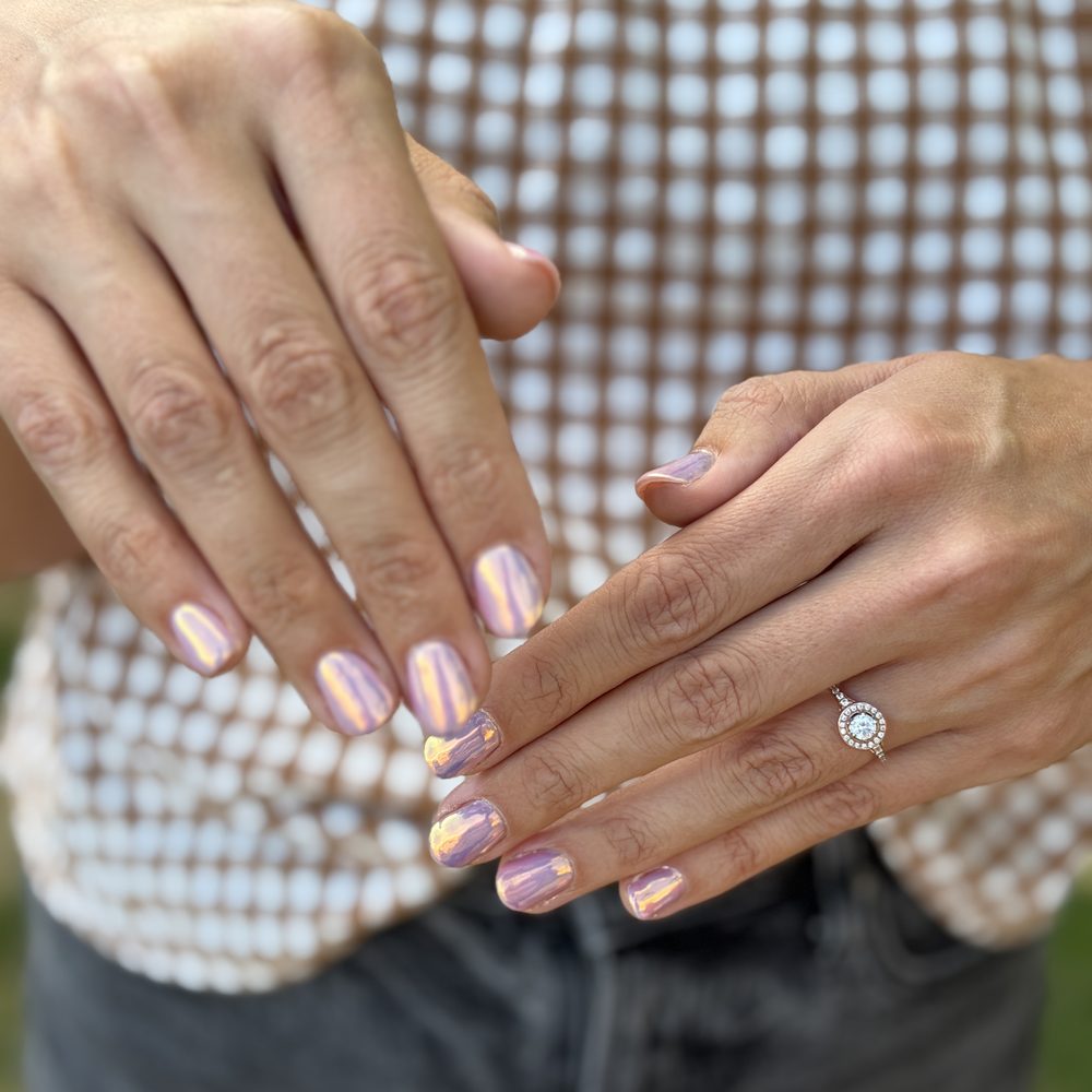 A pearl-pink gel manicure on short natural nails.