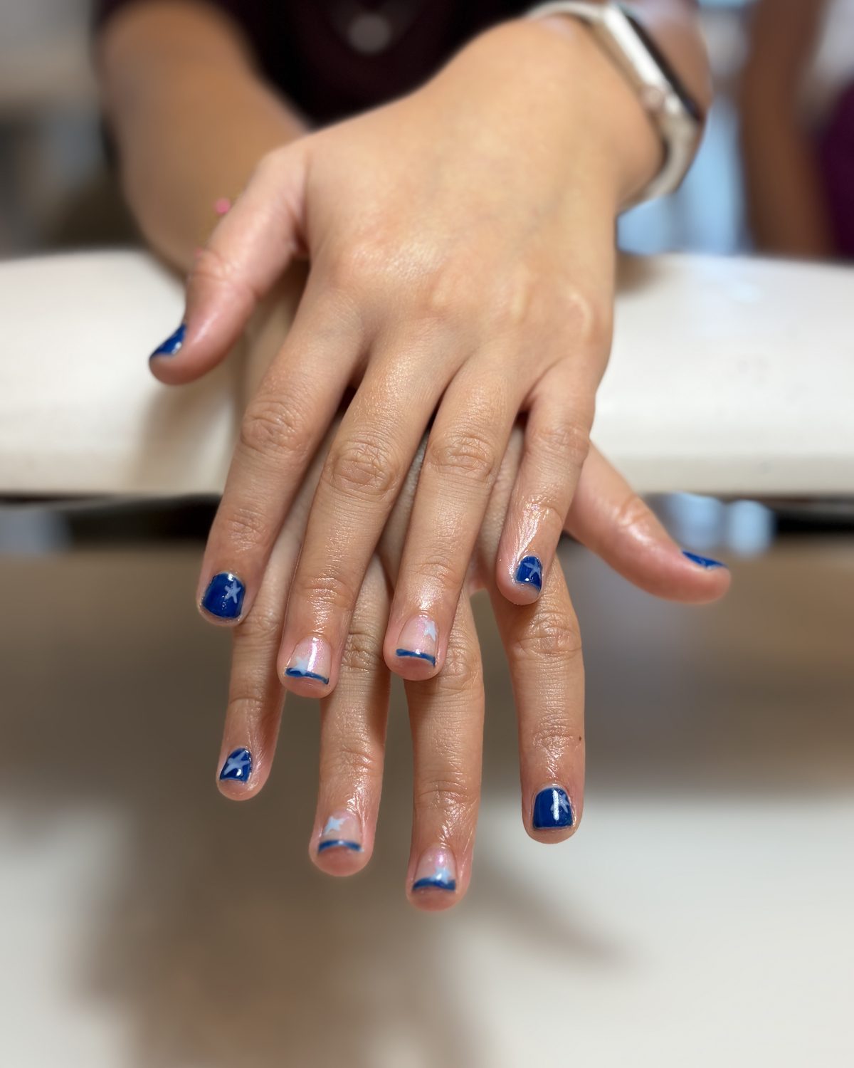 Deep navy gel with a fine white tip on short nails.