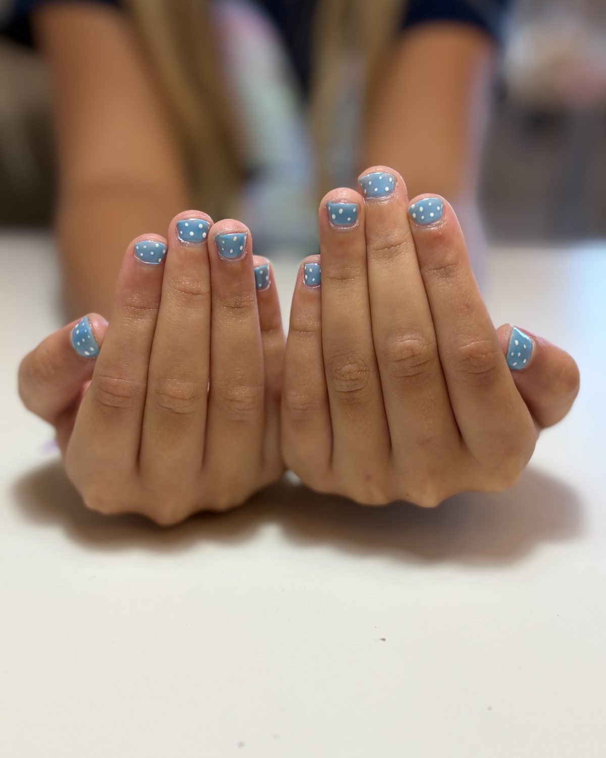 Sky blue nails with speckled glitter across every nail.