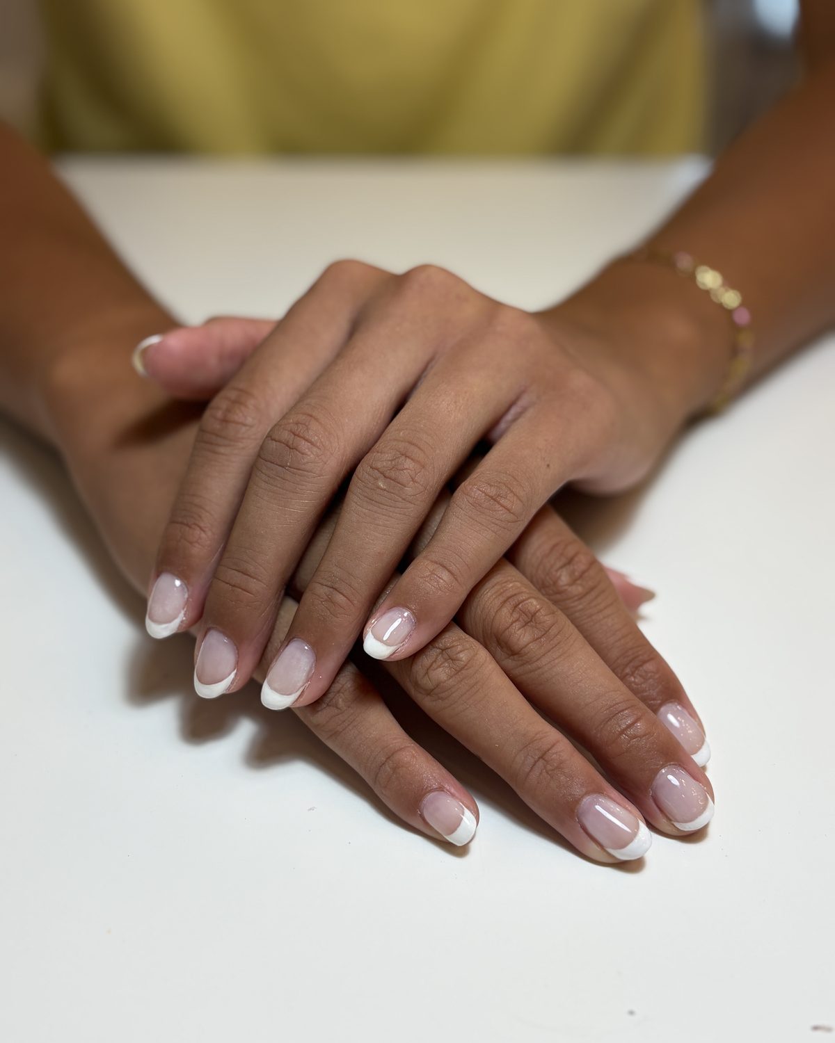 A classic white French tip on short rounded nails.