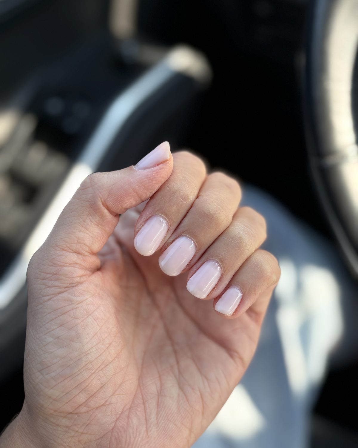A short almond set in a milky ballet pink.